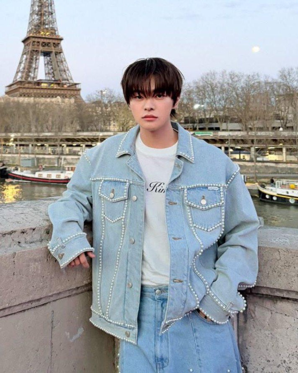 Nolan portrait in a denim jacket beside the Seine