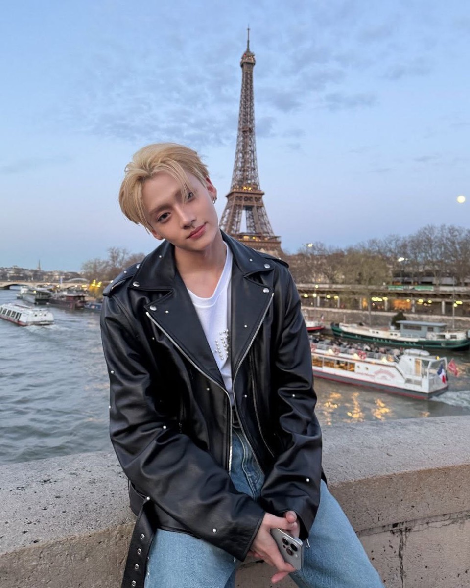 Shezi portrait beside the Seine with the Eiffel Tower behind him